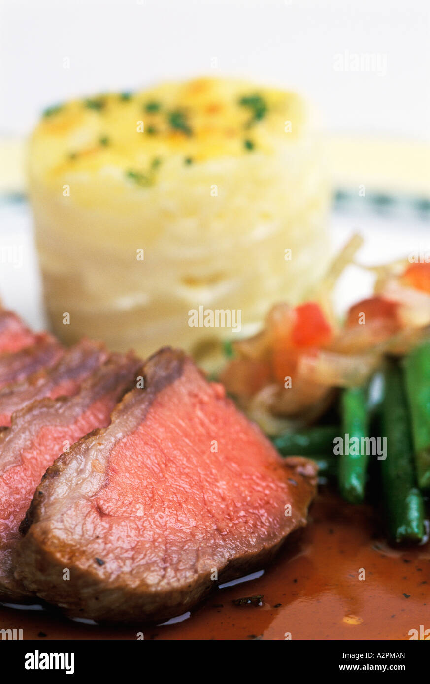 Rare Roast Beef, dauphinoise potatos and green beans with an onion and