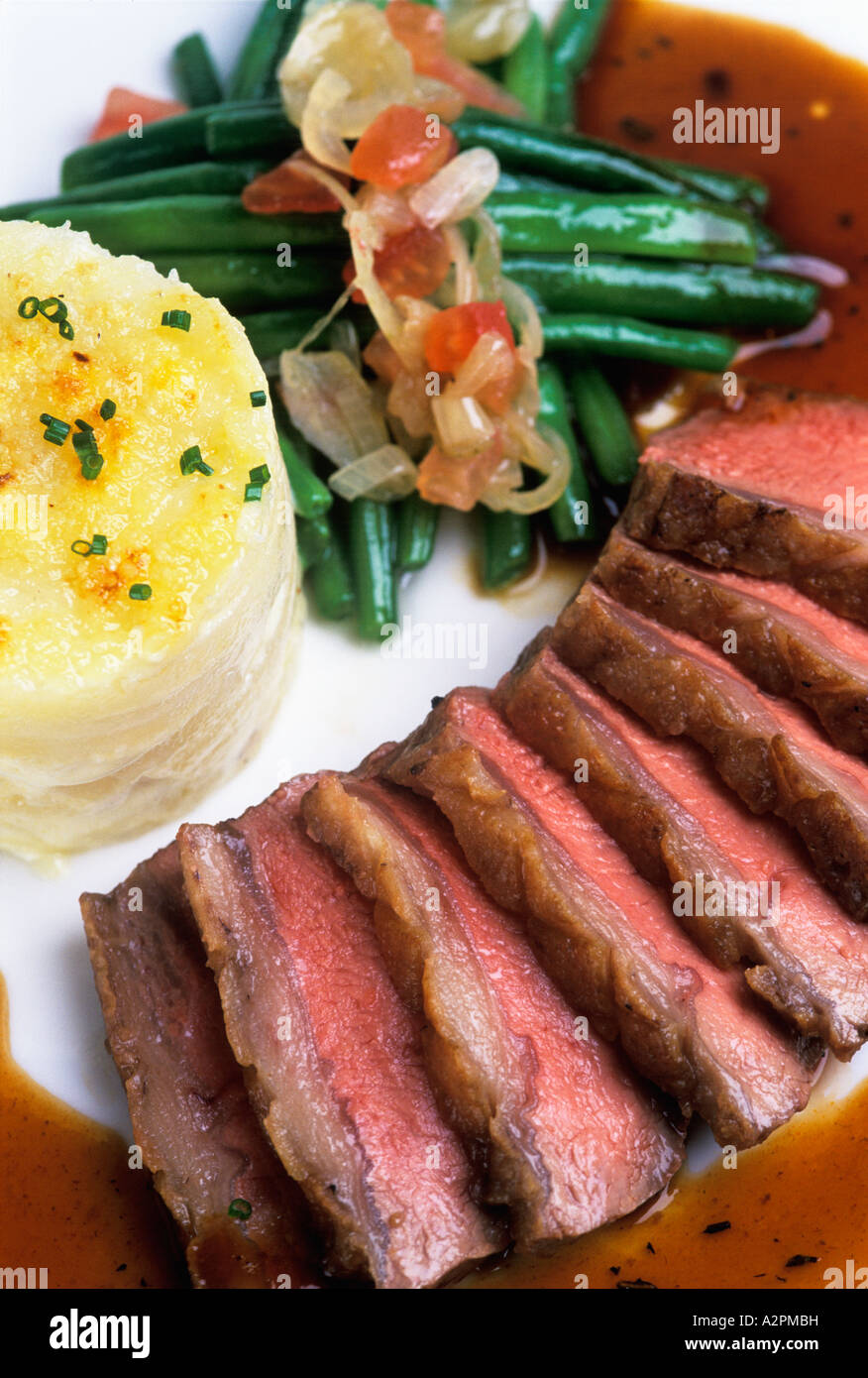 Rare Roast Beef, dauphinoise potatos and green beans with an onion and
