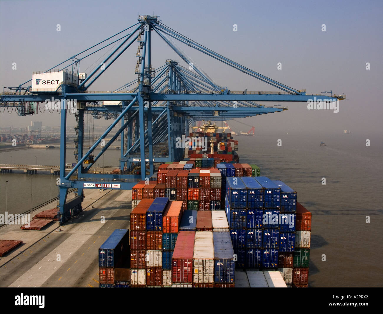Container vessel at container terminal. Cargo operations in progress. Stock Photo