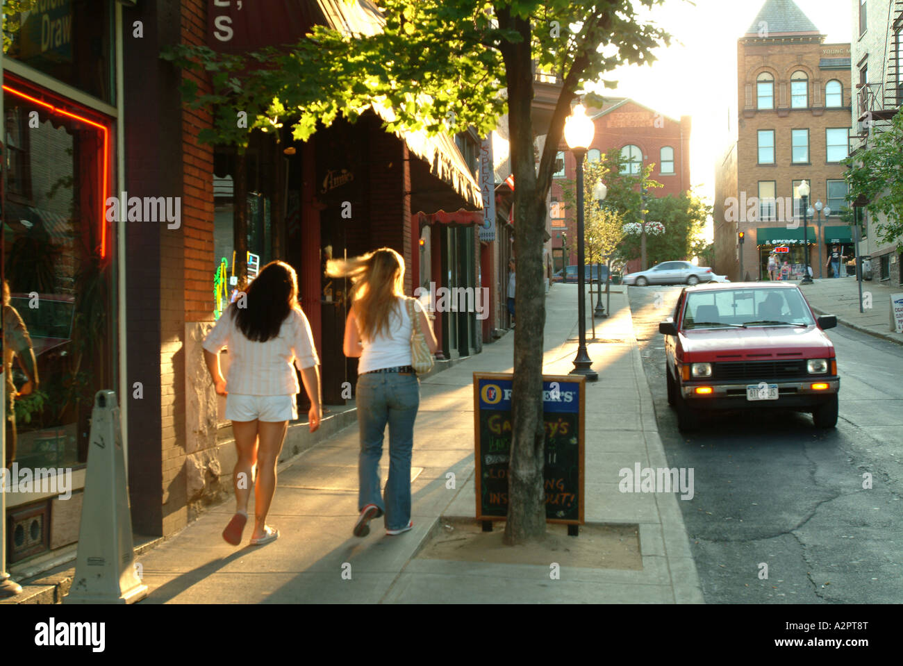 Women walking up Caroline Street into the afternoon sun Stock Photo