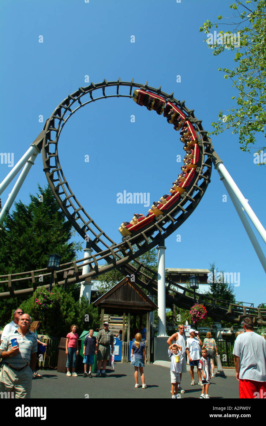 A rollercoaster twists spirals loop the loops overhead at Hershey Park Stock Photo