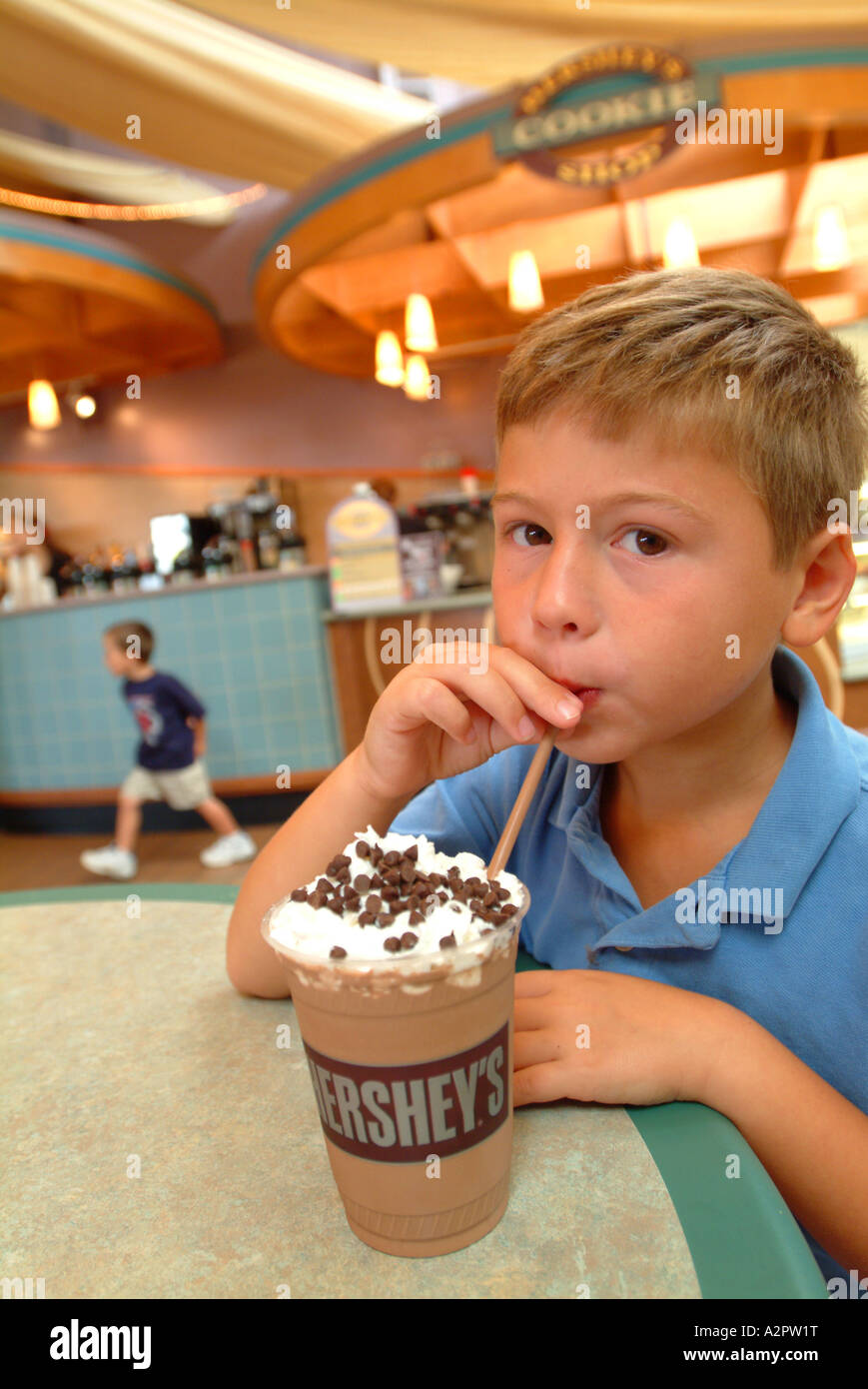 A boy seven 7 MR enjoys a chocolate iced drink at Hershey s Chocolate World cafe Stock Photo