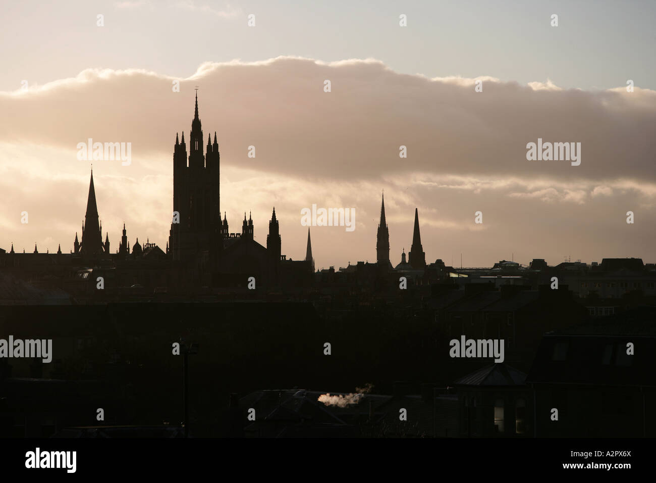Aberdeen city, Scotland skyline at dusk with church cathedral spire silhouetted against warm sky Stock Photo