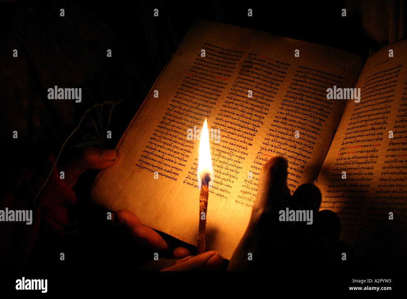Reading from an ancient lambskin religious text inside one of Lalibels's churches, Lalibela, Ethiopia Stock Photo