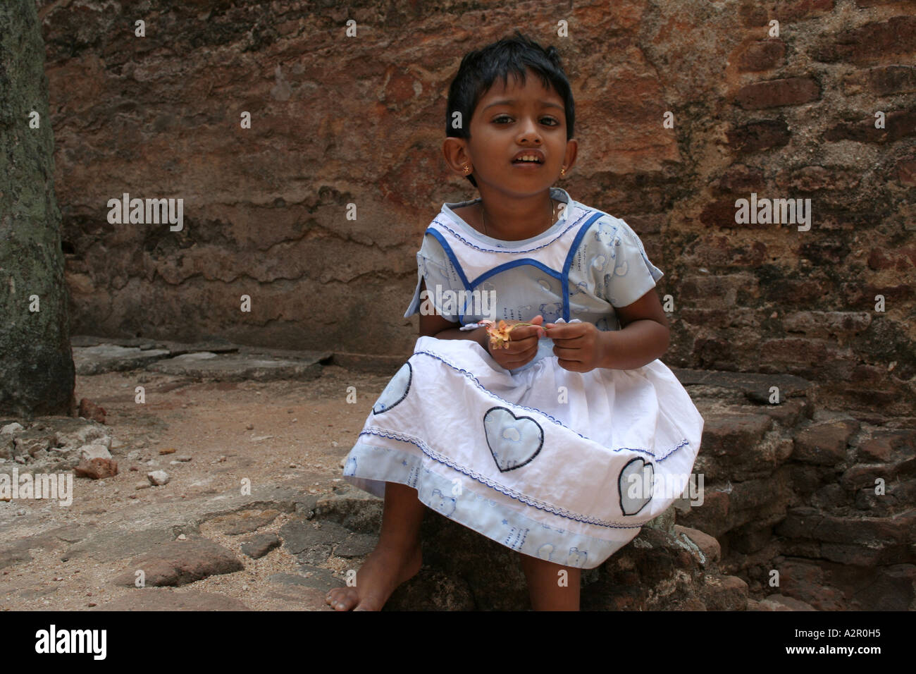 A young girl inside the temple ruins of Lankatilaka in Polonnaruwa, Sri Lanka Stock Photo