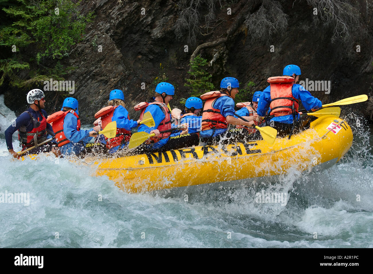 Riding high while white water rafting on cold Kananaskis river Canoe Meadows Alberta Canada Stock Photo