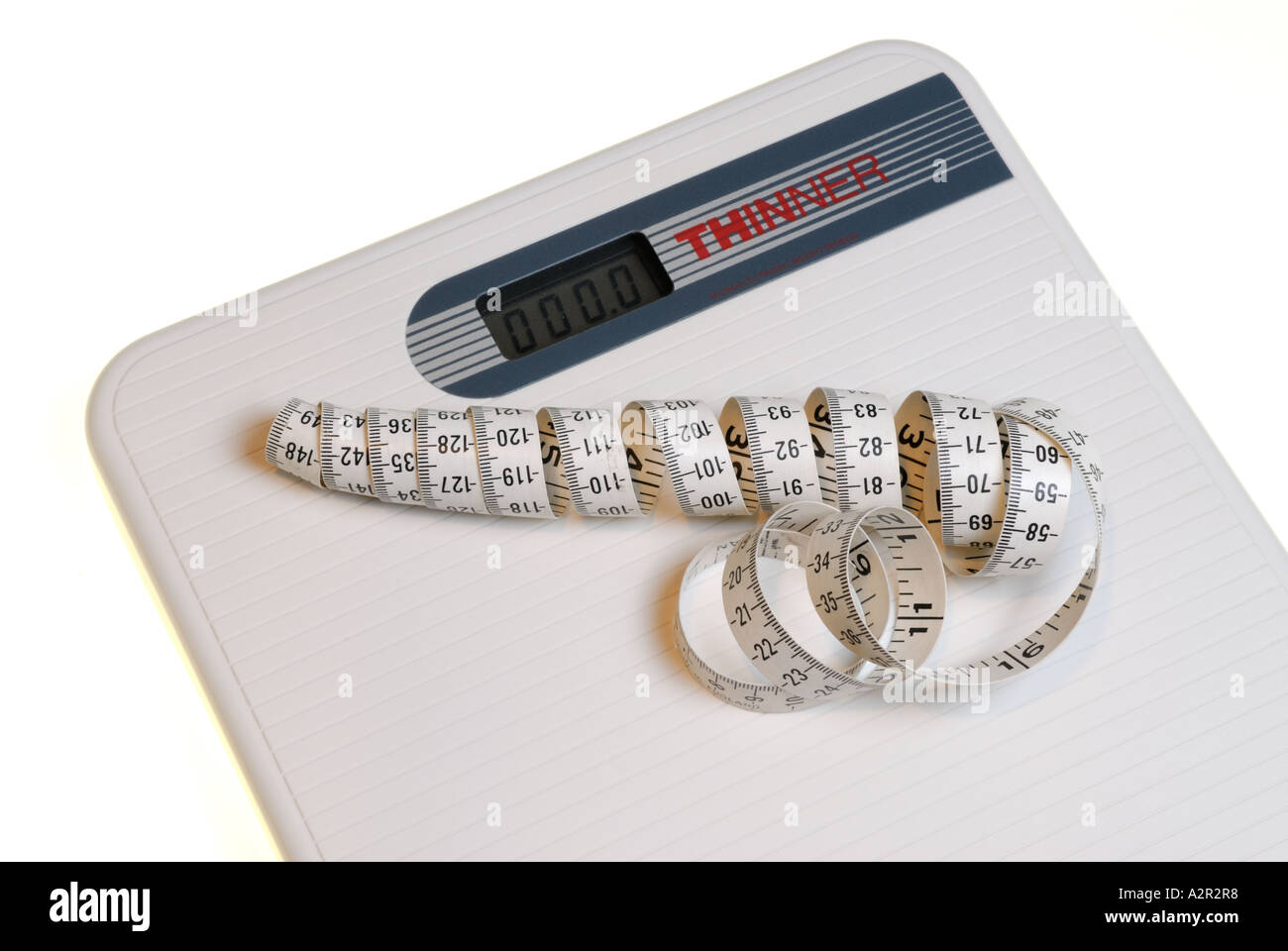 Coiled measuring tape on digital bathroom scale for dieting Stock Photo