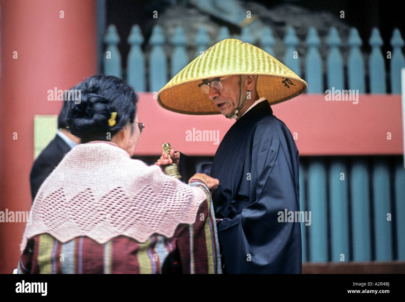 Buddhist monk begging at the entrance of the Asakusa Kannon Buddhist temple Tokyo Japan Stock Photo