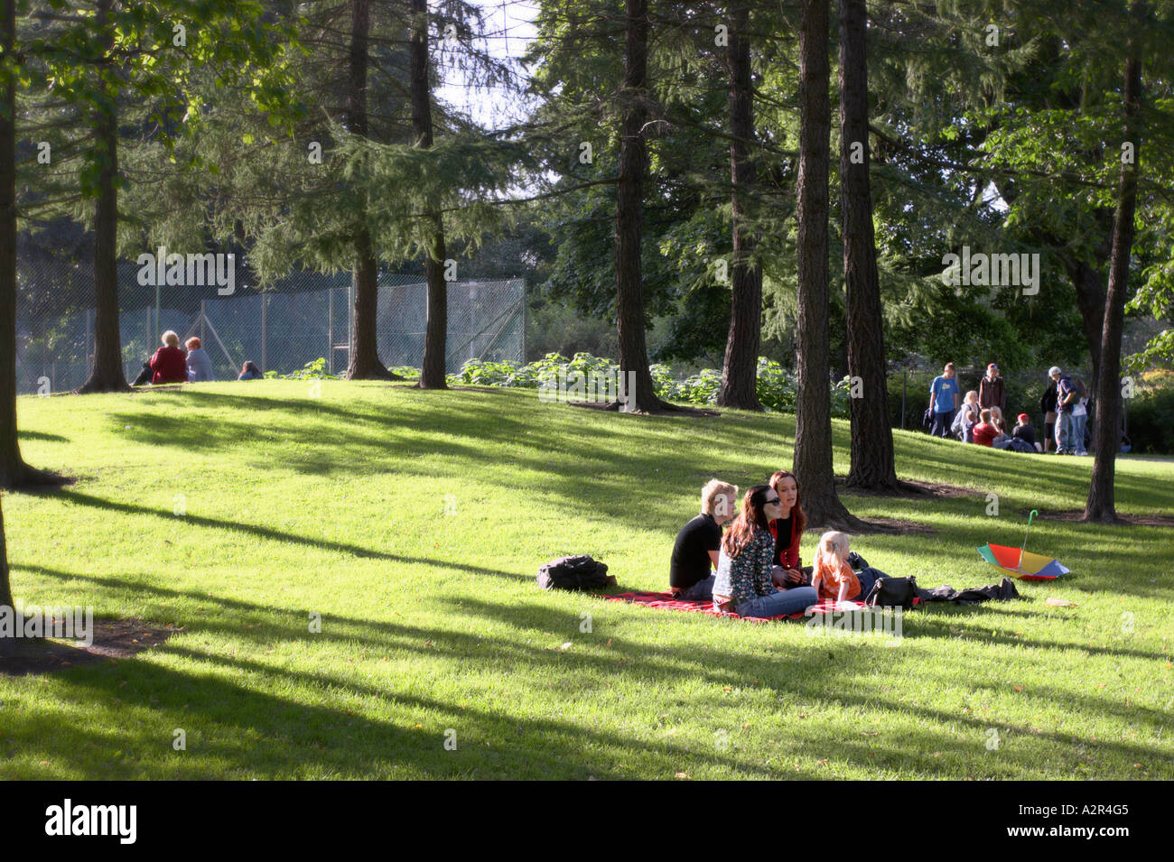 People enjoying a late summer evening in a park, Kaisaniemi, Helsinki, Finland Stock Photo