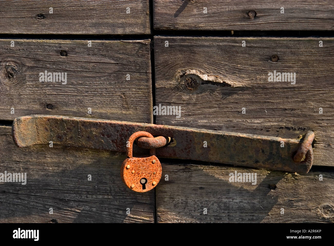 Rusty Padlock on an old door Stock Photo - Alamy