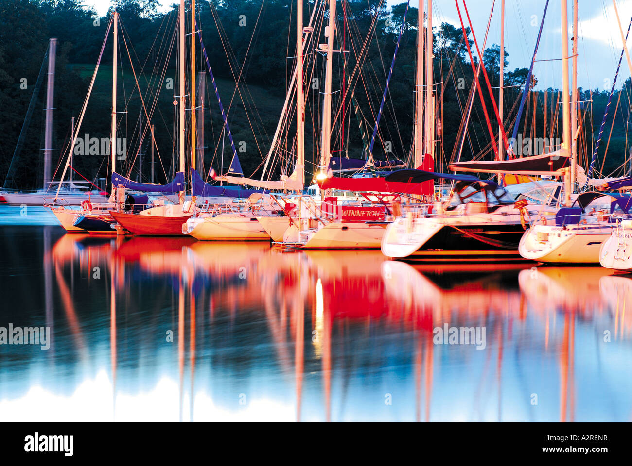 Yachts reflecting in the water with evening light, harbour of La Roche Bernard, Brittany, France Stock Photo