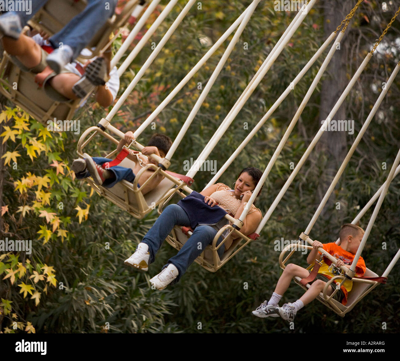 Talking on a cel cell phone on a ride Six Flags Magic Mountain Rides Valencia California United States of America Stock Photo