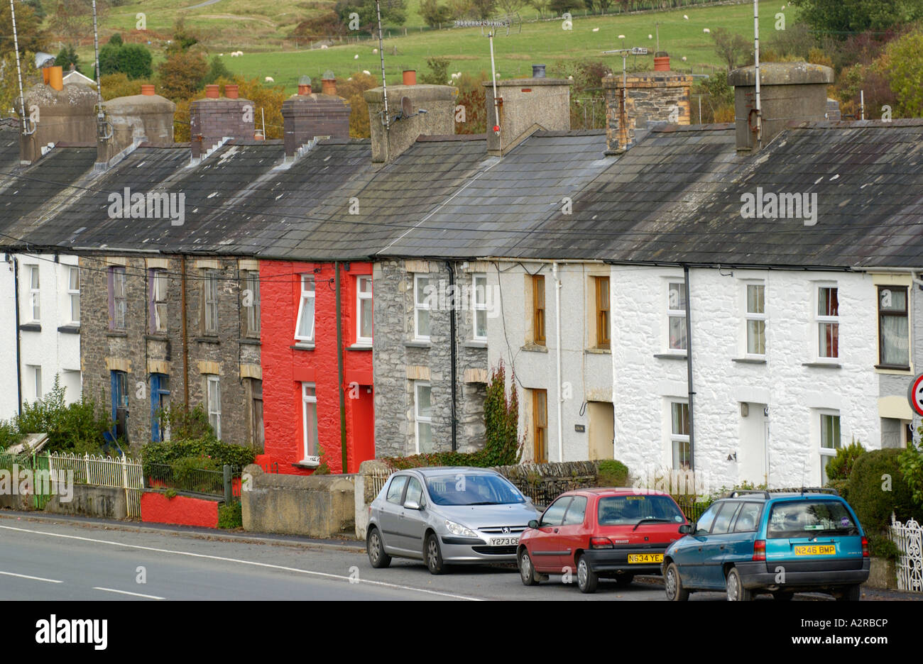 Row of terraced houses with cars parked outside in village of Pontrhydfendigaid Ceredigion Mid Wales UK Stock Photo