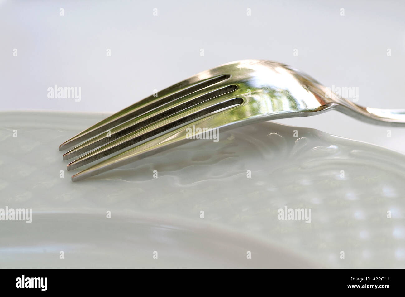 Fork on plate Stock Photo Alamy