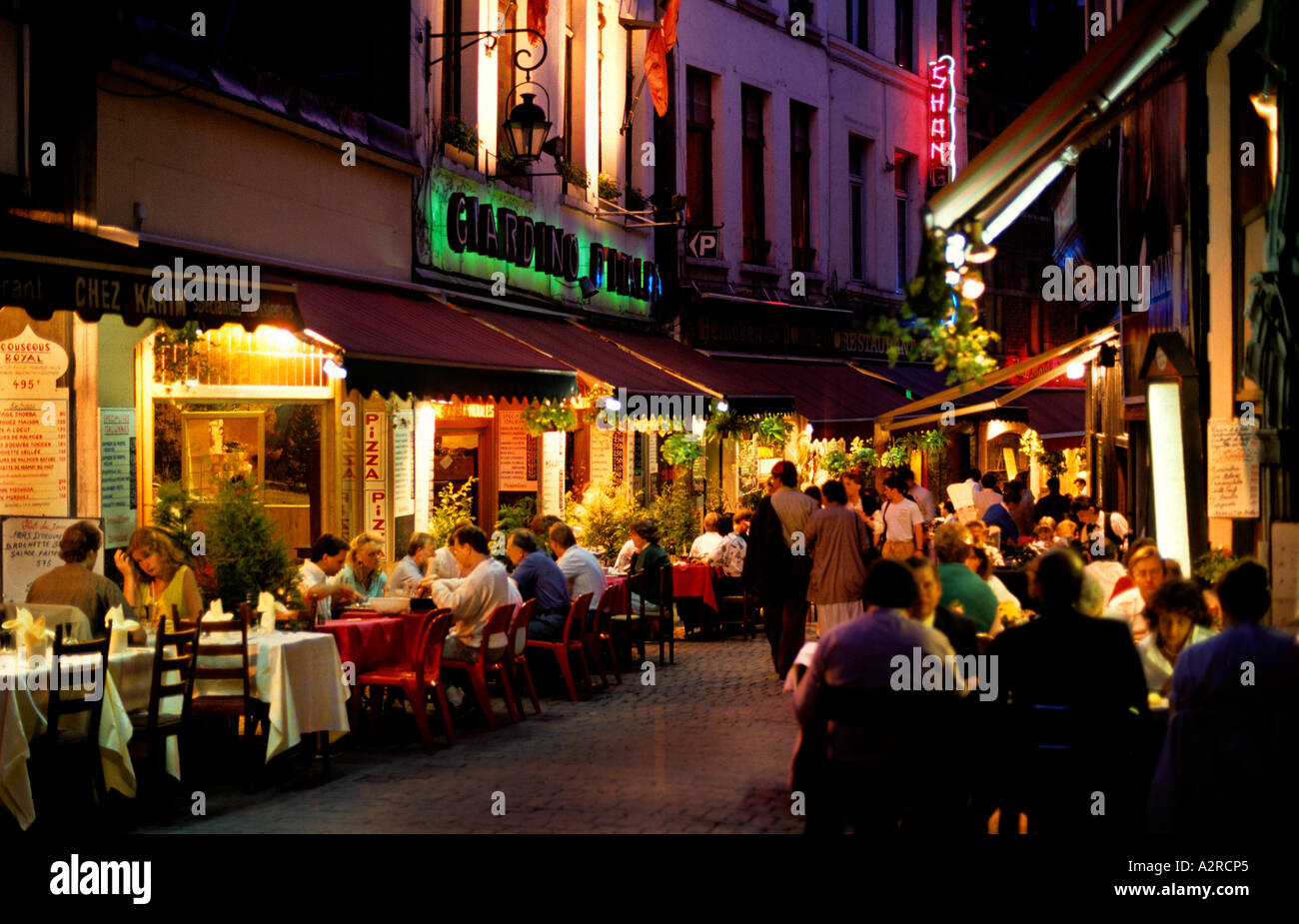 Open air tables outside fish restaurants in Rue des Bouchers near grand Place Stock Photo