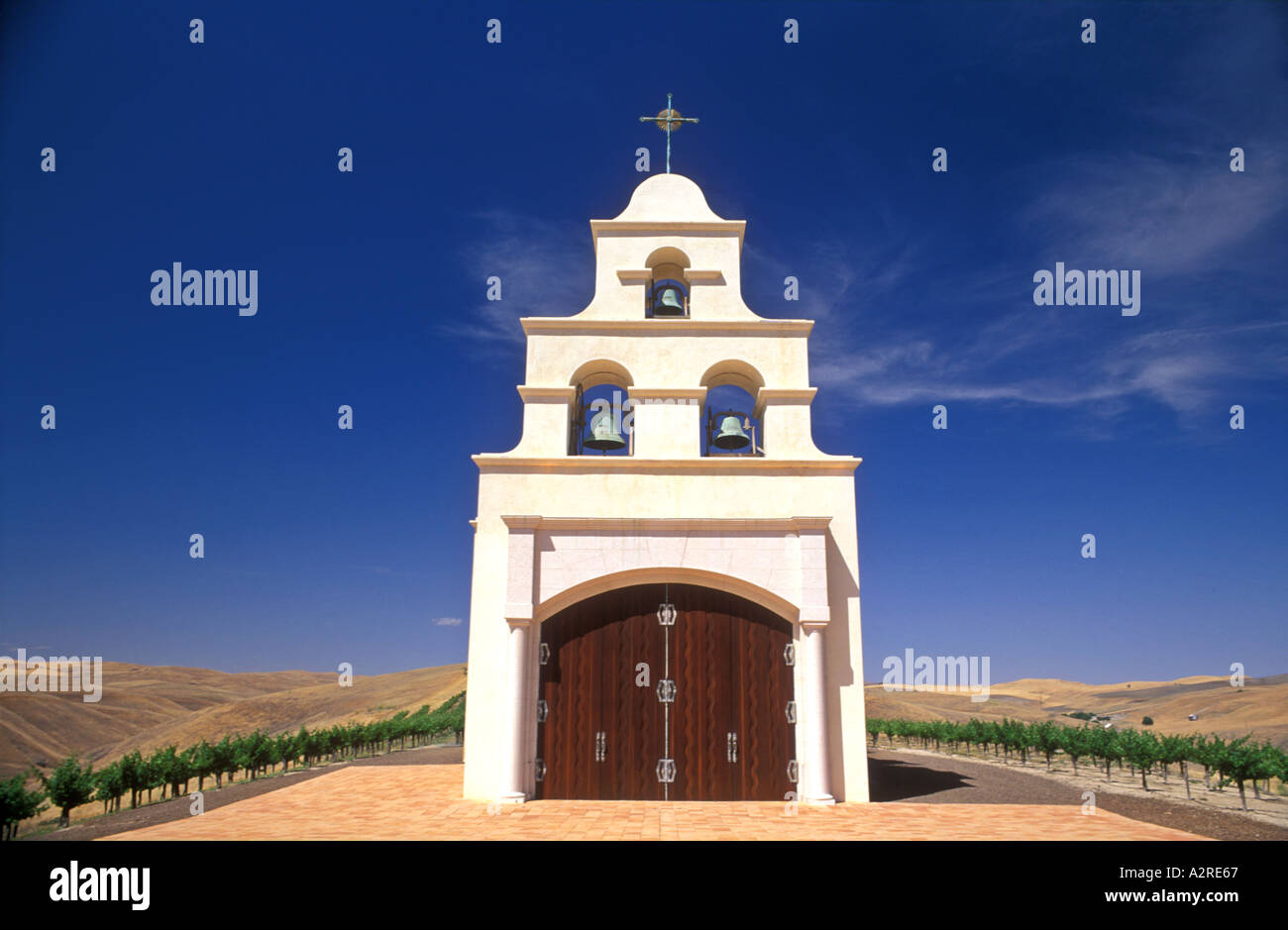 USA, California, Paso Robles, Spanish Mission style church on hill with grape vineyard Stock Photo