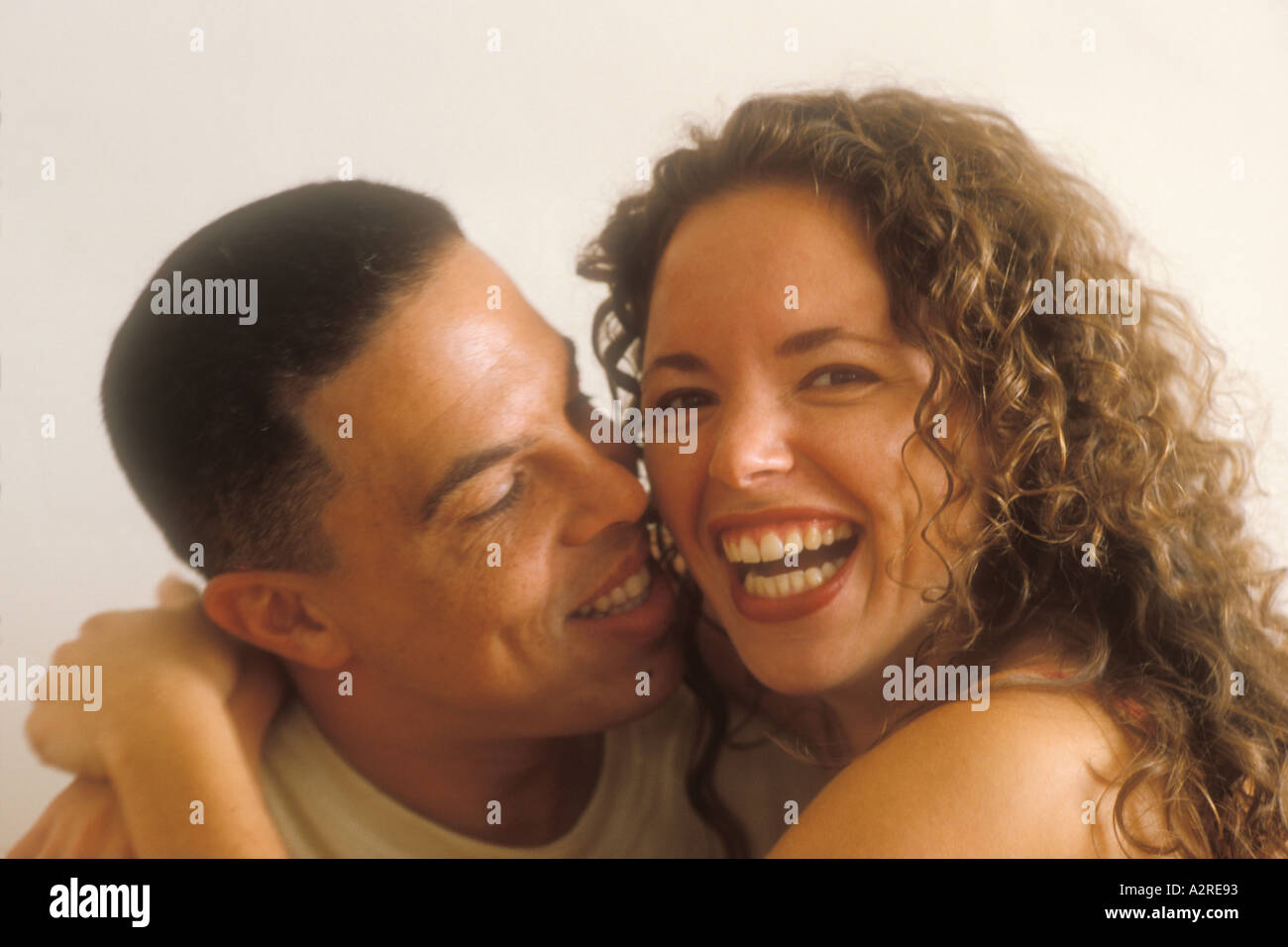 Hispanic man kissing mixed Hispanic woman Stock Photo