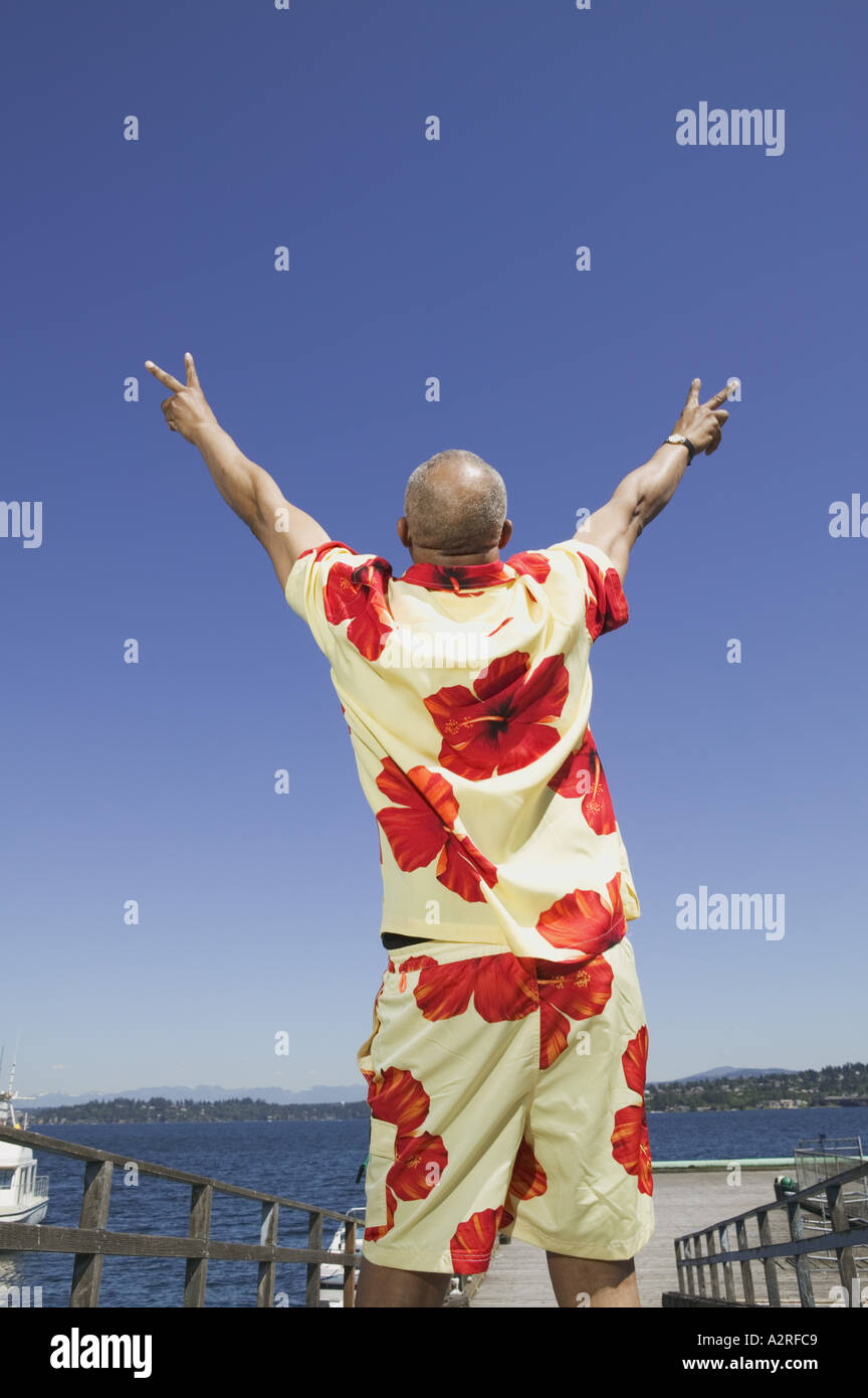 Middle aged man flashing the peace sign Stock Photo Alamy