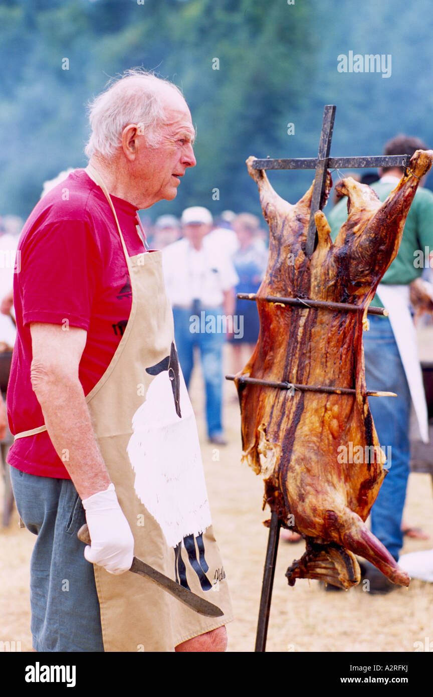 Chef carving Barbecued Saturna Island Lamb at Annual Summer Barbeque, Southern Gulf Islands, BC