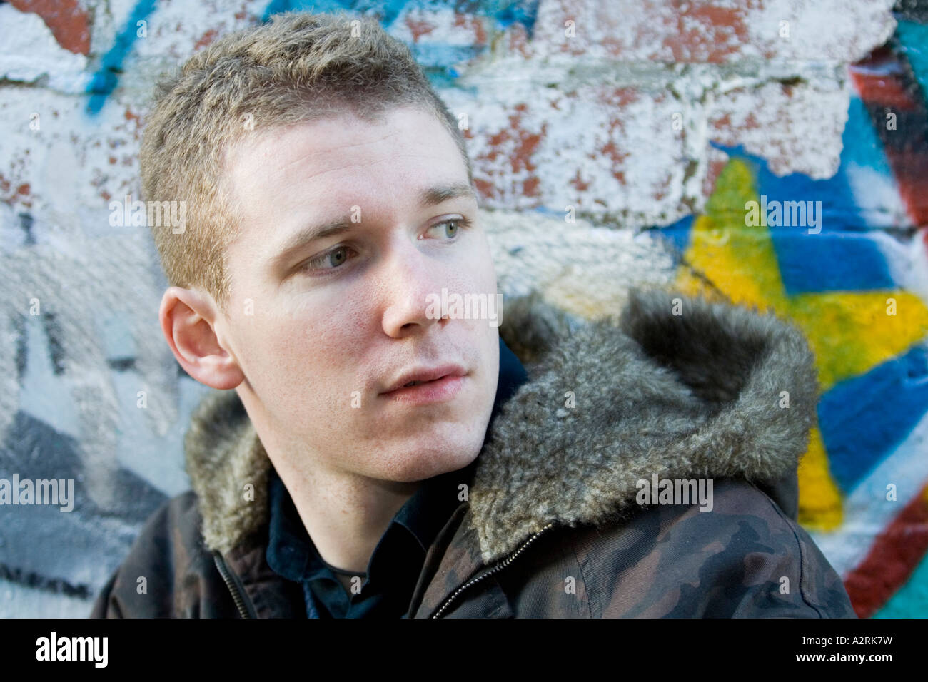 young teenage boy teenager rebellious male youth graffiti brick wall