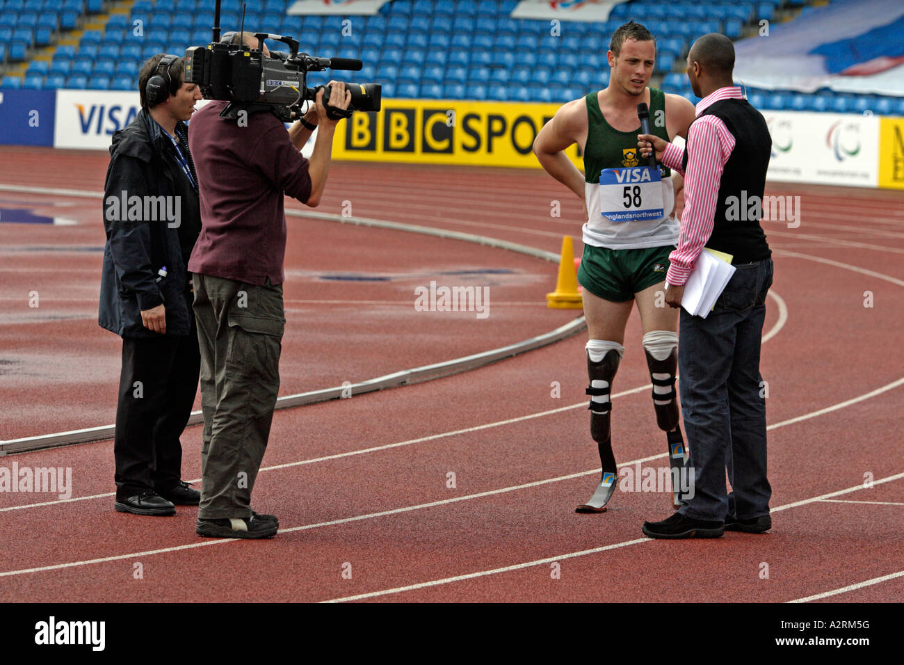 Oscar Pistorius of South Africa being interviewed by Colin Jackson for BBC Sport after winning the men's T44 200m Stock Photo