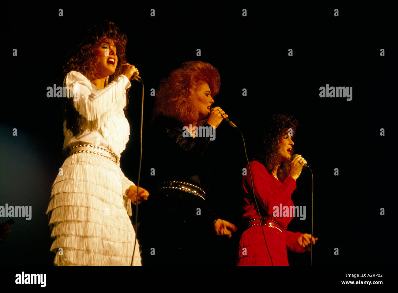 trio of female country and western singers performing on stage branson