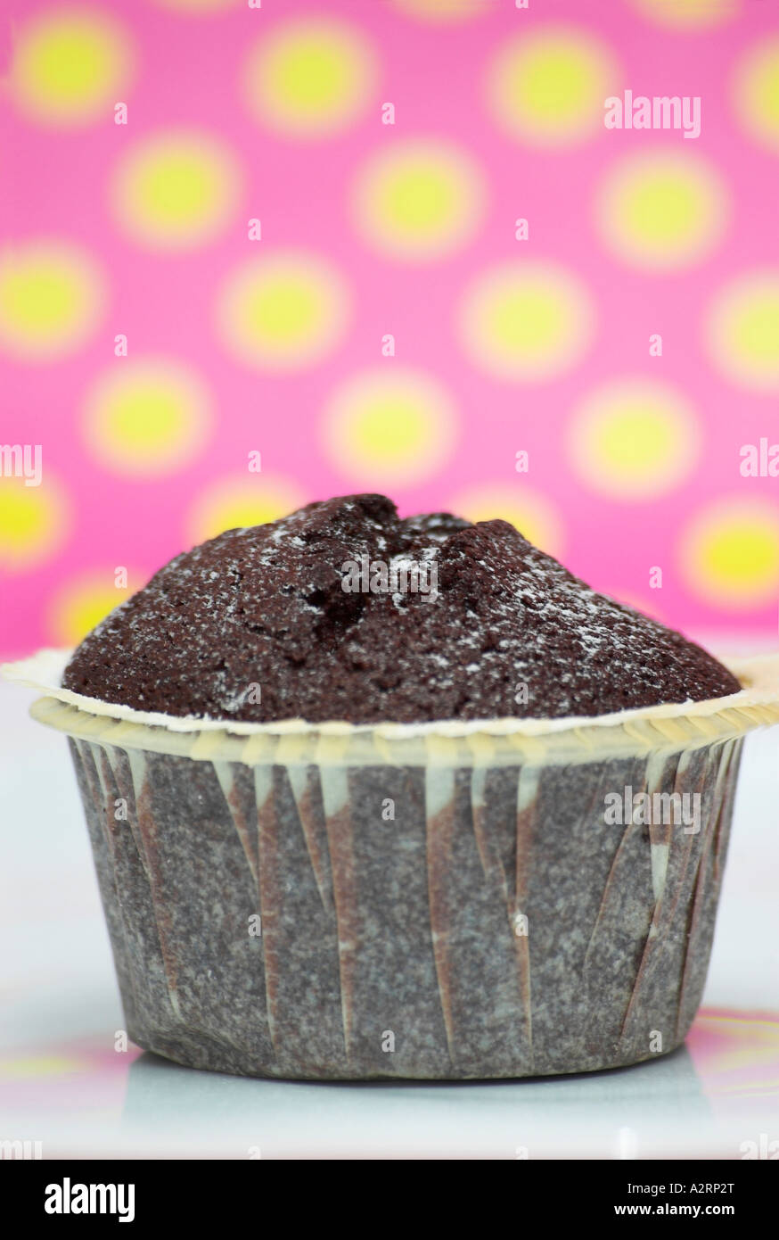 Close up of a chocolate muffin on a plate pink background Stock Photo ...