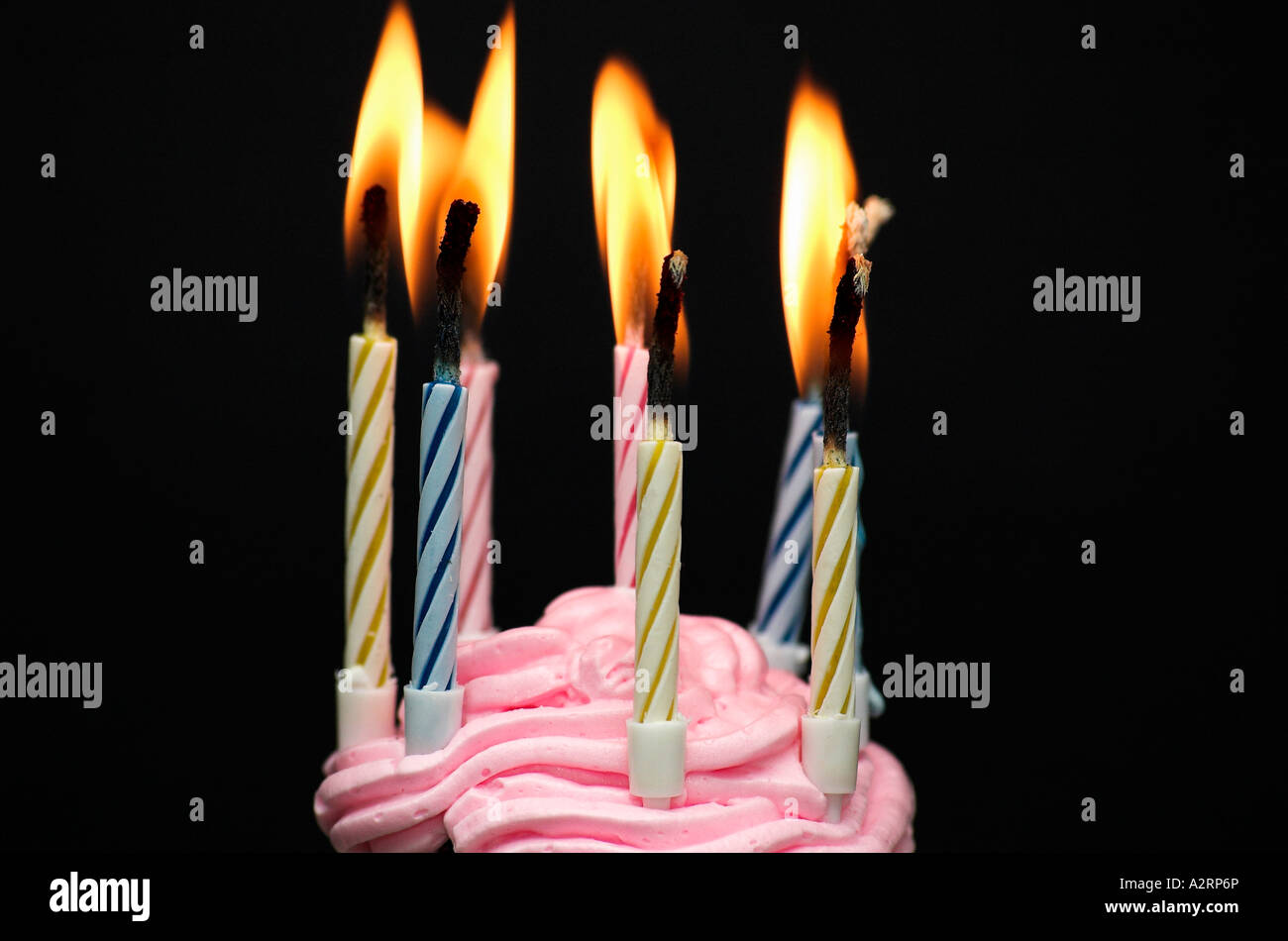 Close up of lit candles on birthday cake black background Stock Photo ...