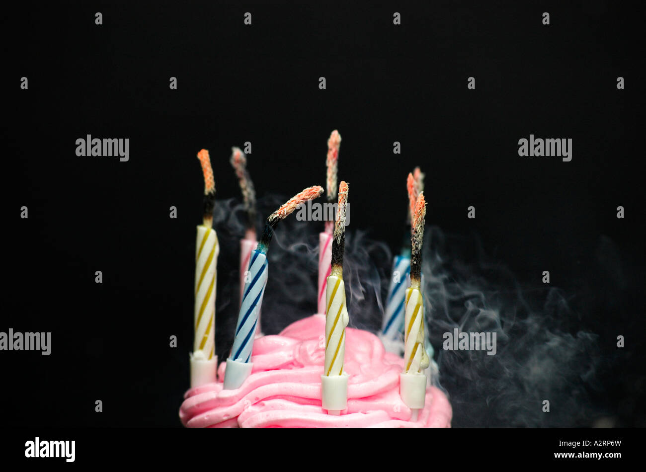 Smoking candles on birthday cake black background Stock Photo Alamy