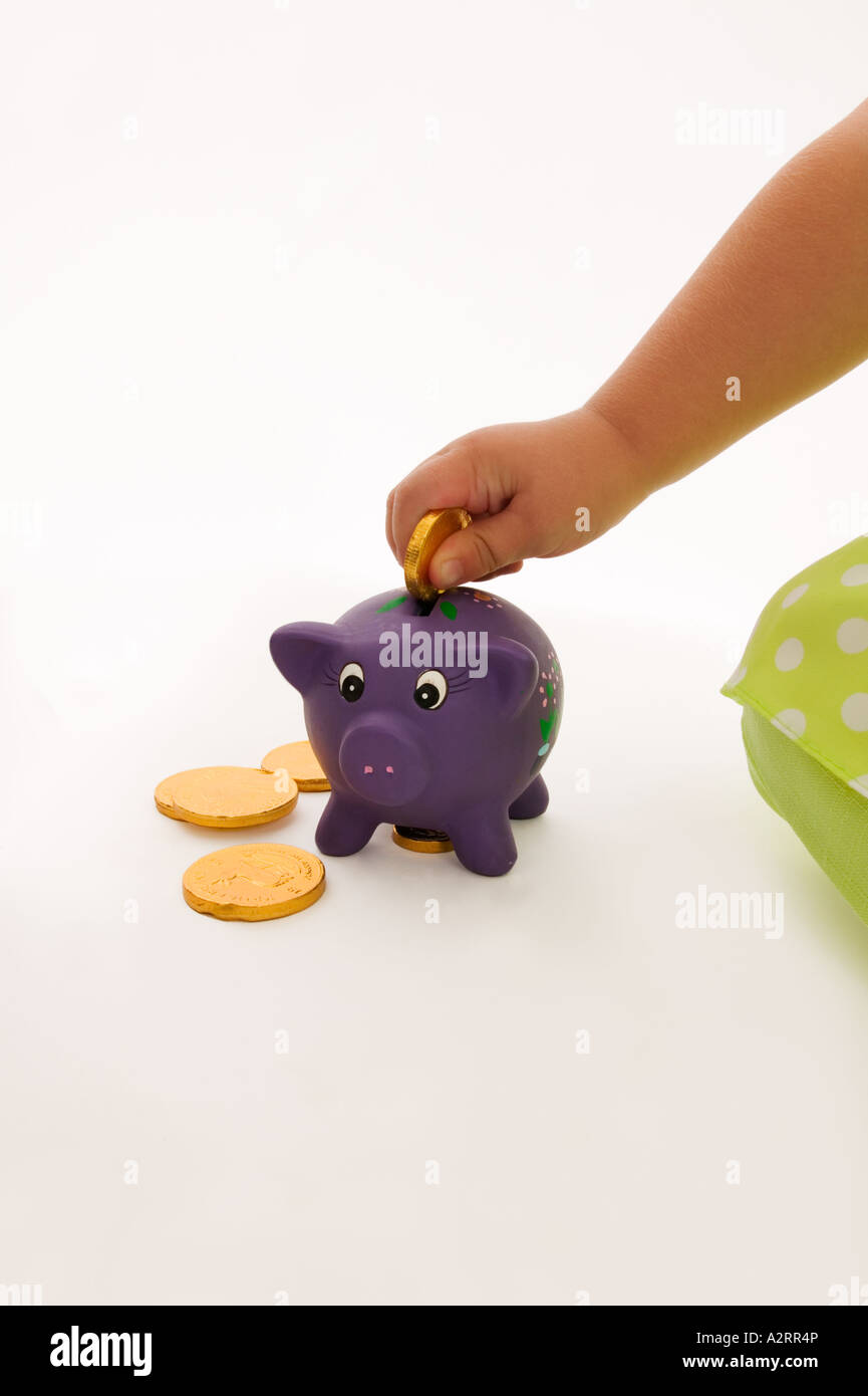 Child 18 months with piggybank Model released Studio shot Stock Photo