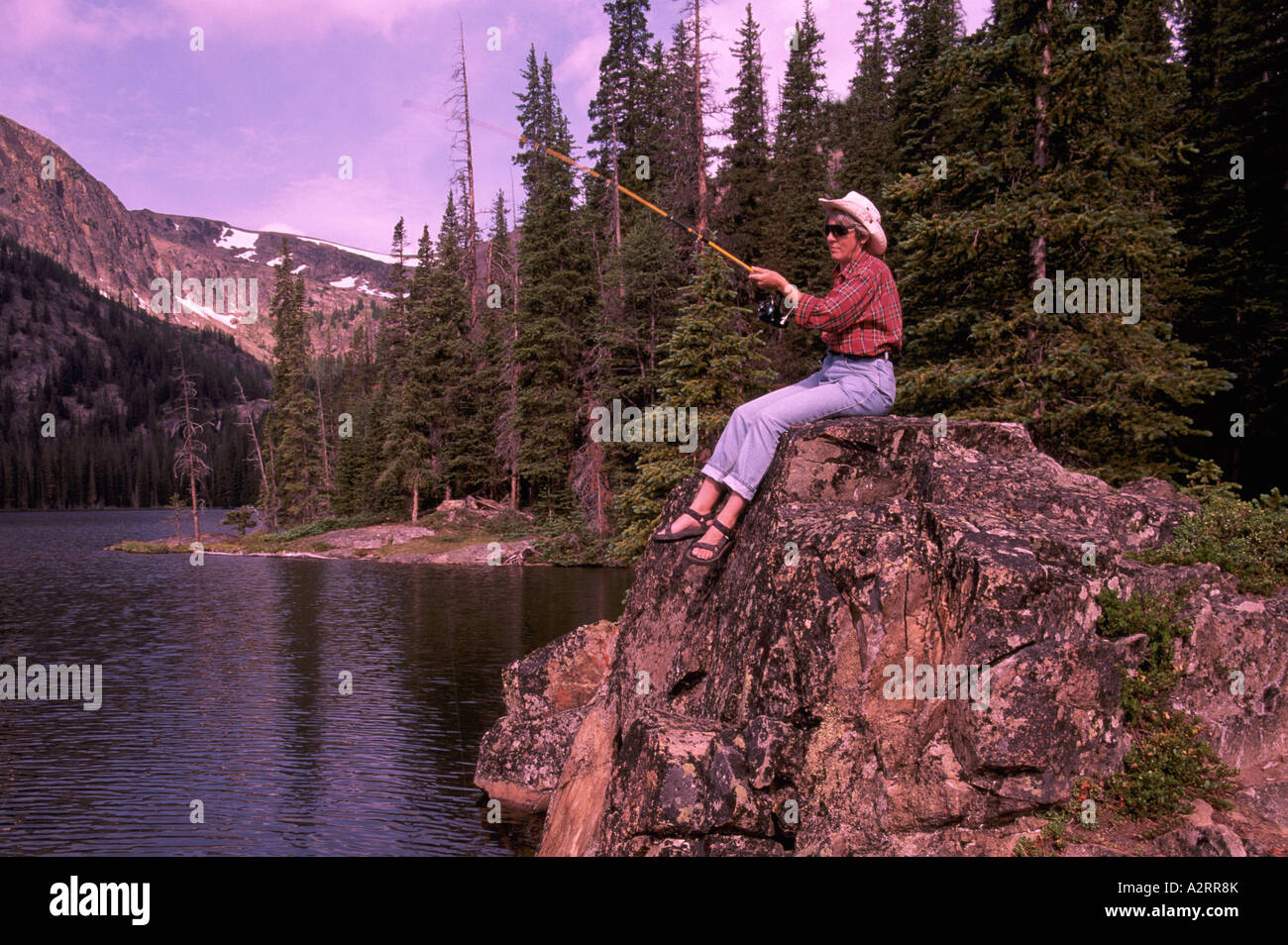 Woman fishing from Shore of Quiniscoe Lake in Cathedral Provincial Park, near Keremeos, BC, British Columbia, Canada Stock Photo