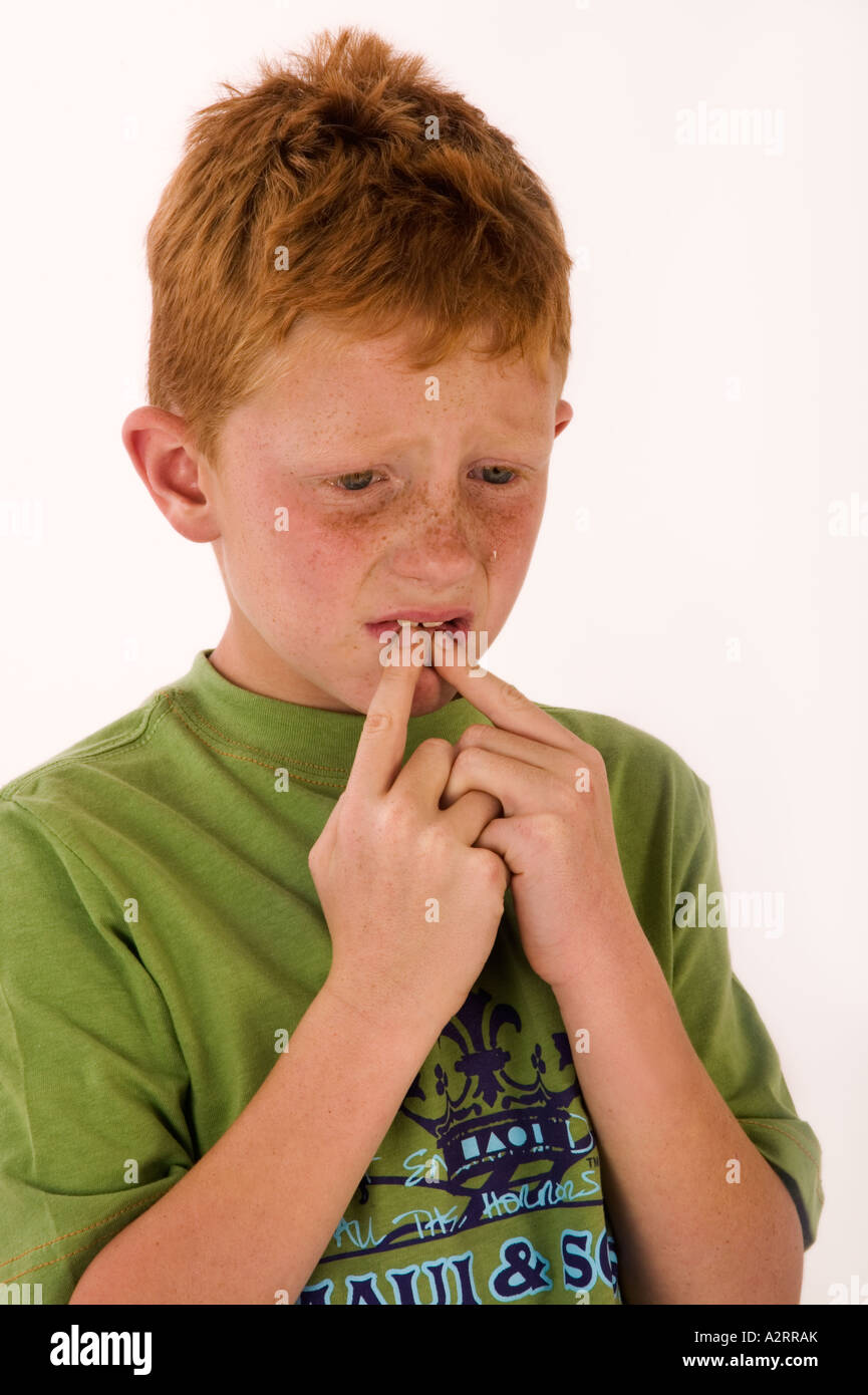 Crying young boy with red hair and freckles crying age 7 Model released Studio shot Stock Photo