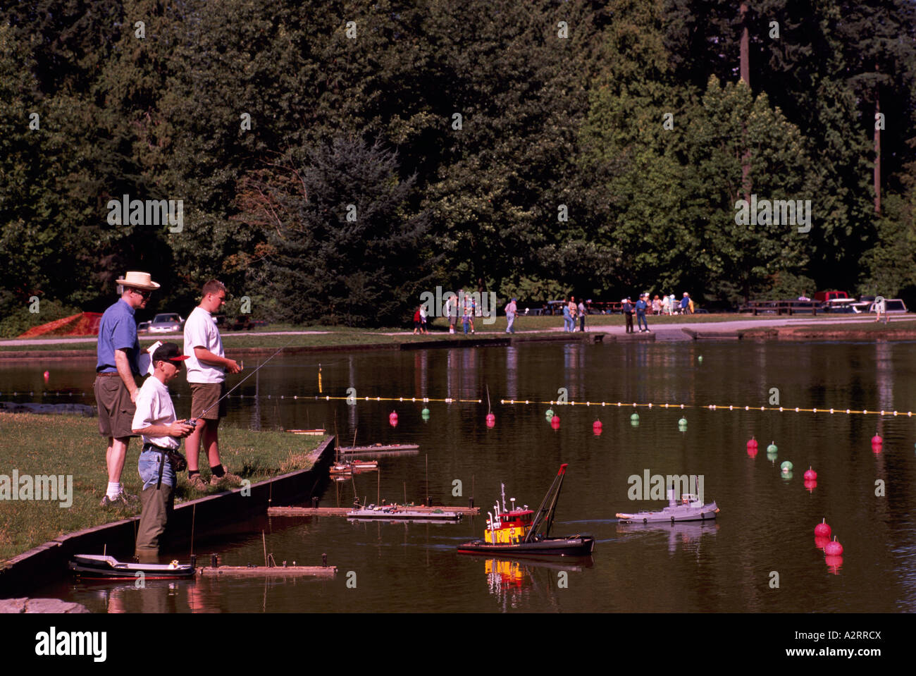 Senior Men operating Remotecontrolled Model Boats as a Hobby in Spare