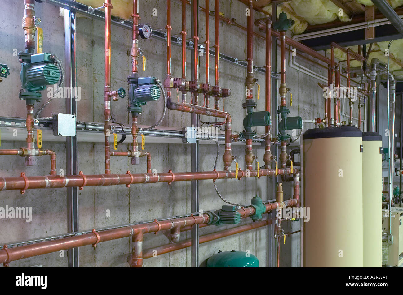 Metal Copper Water Pipes With Hot Water Heaters In Basement Stock Photo
