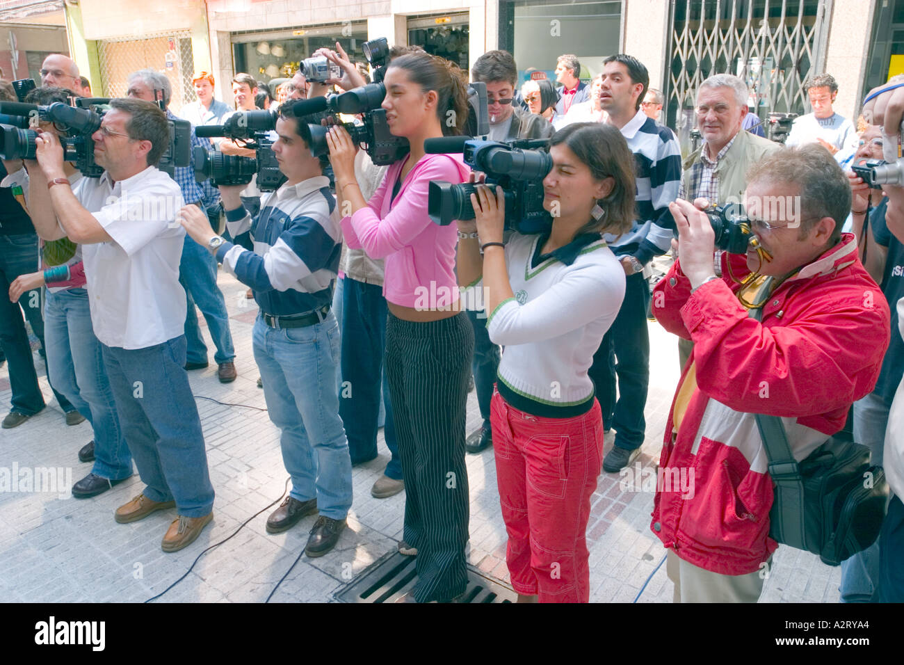 Group of TV camerapeople covering an event Stock Photo