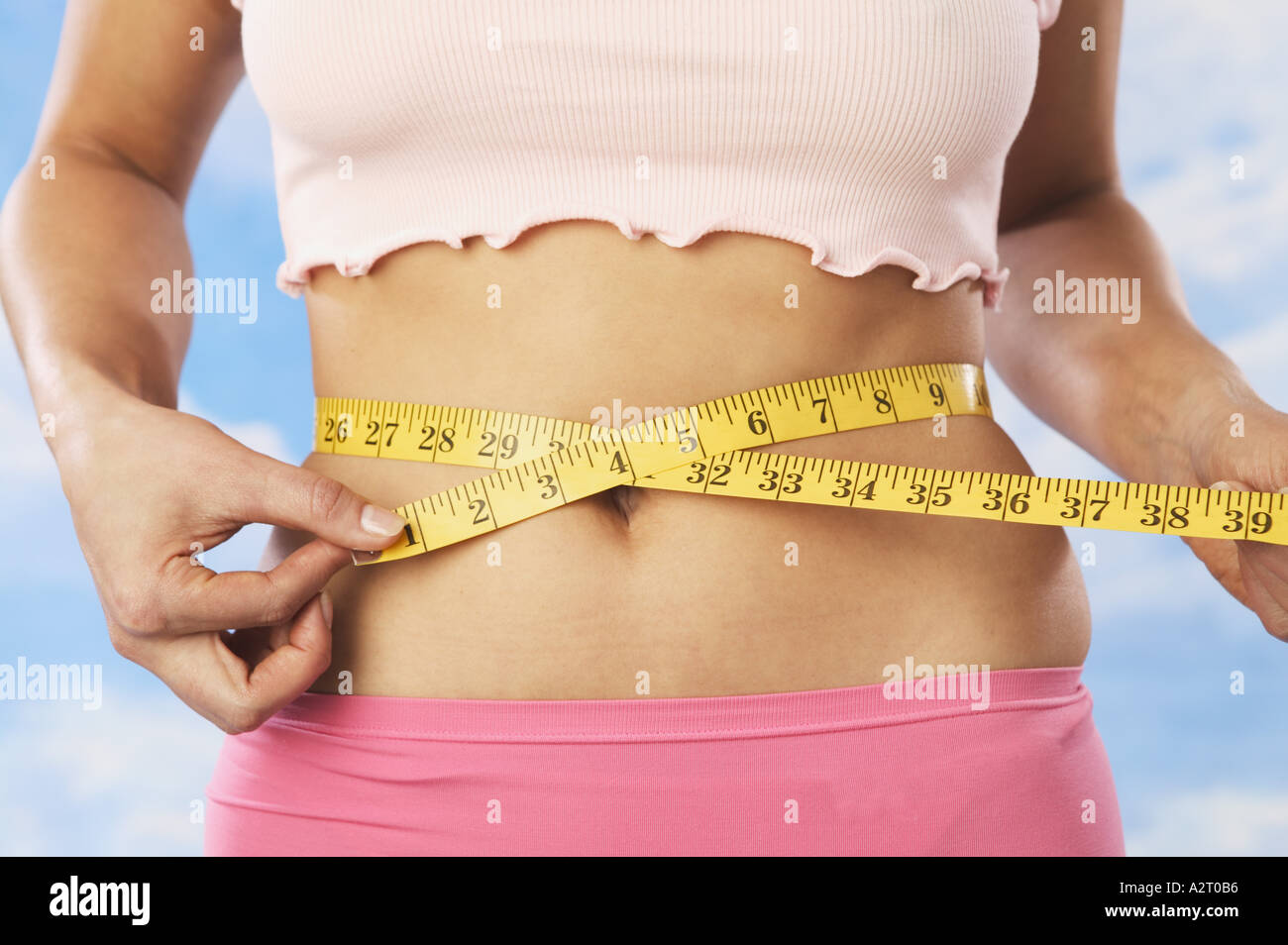 A woman measuring her waist Stock Photo Alamy