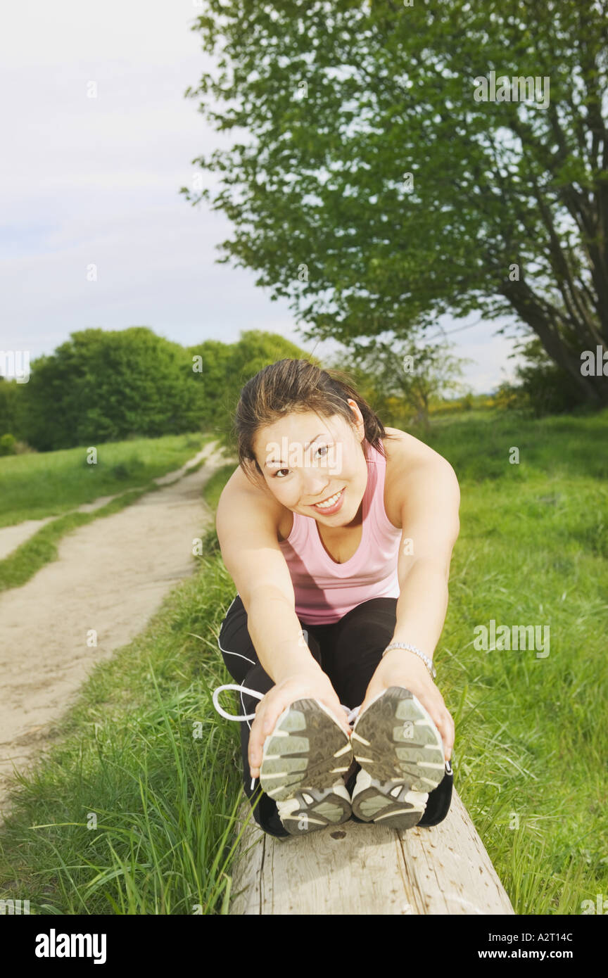 A young woman smiling and stretching Stock Photo