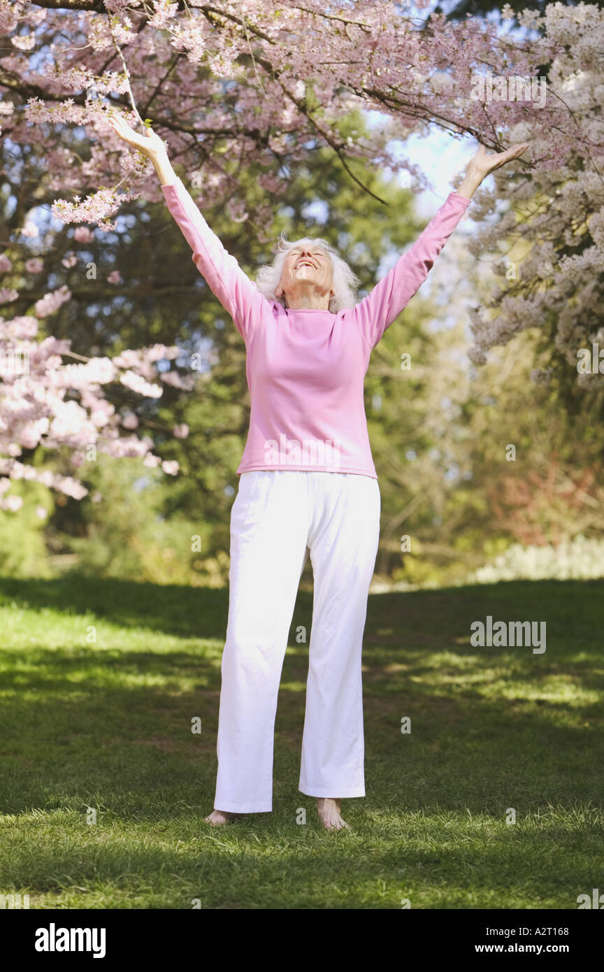 A senior woman with outstretched arms Stock Photo