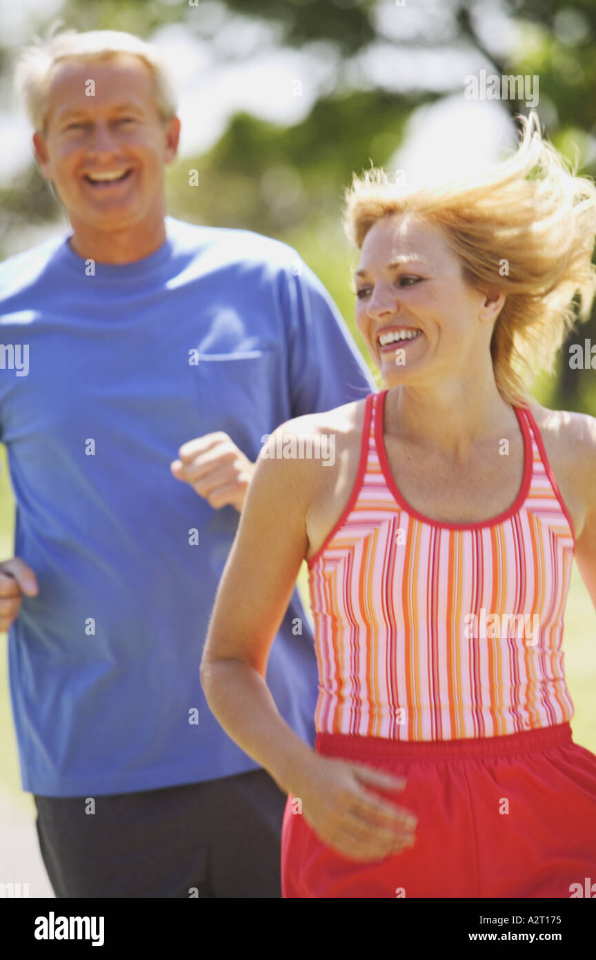 A middle aged couple jogging Stock Photo
