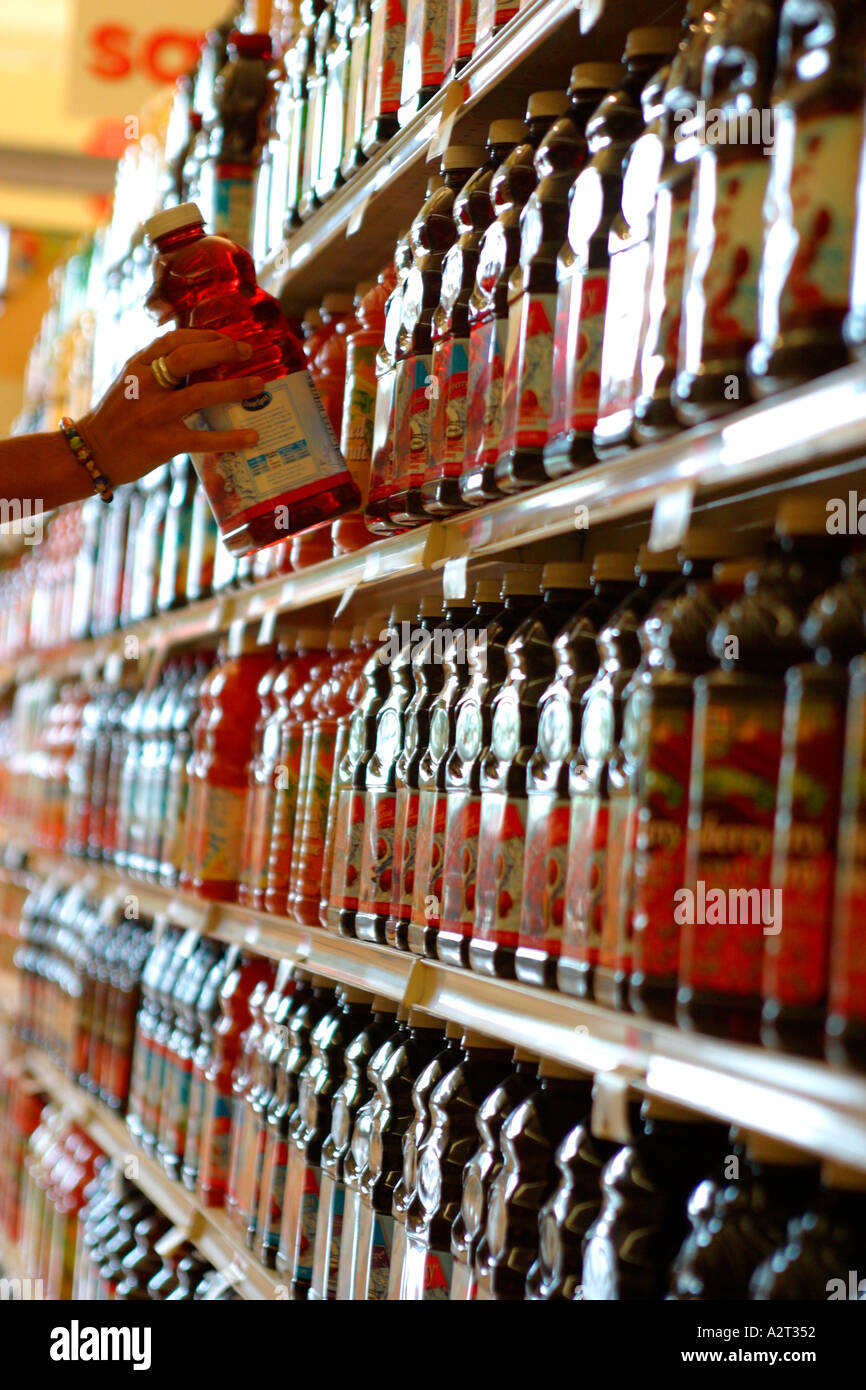 Woman Buying Juice at Grocery Store Stock Photo