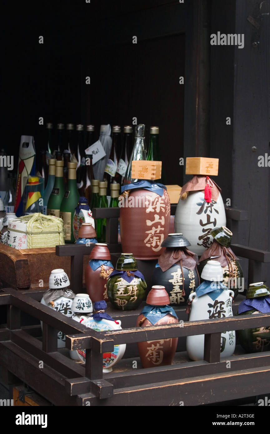 A variety of sake rice wine bottles on display in front of a sake