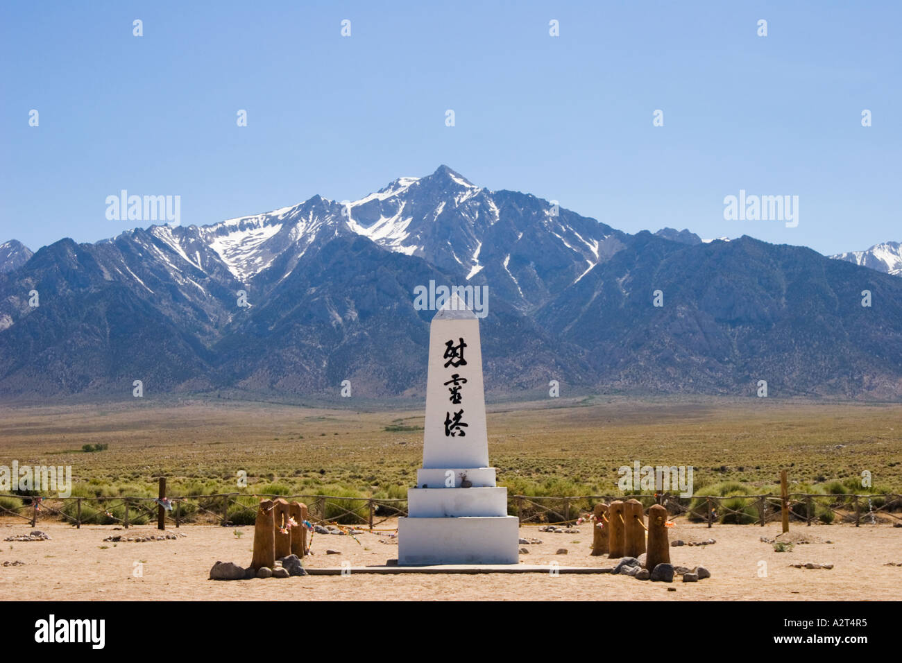 Graveyard monument and the Sierra Nevada mountains Manzanar National Historic Site Inyo County California Stock Photo
