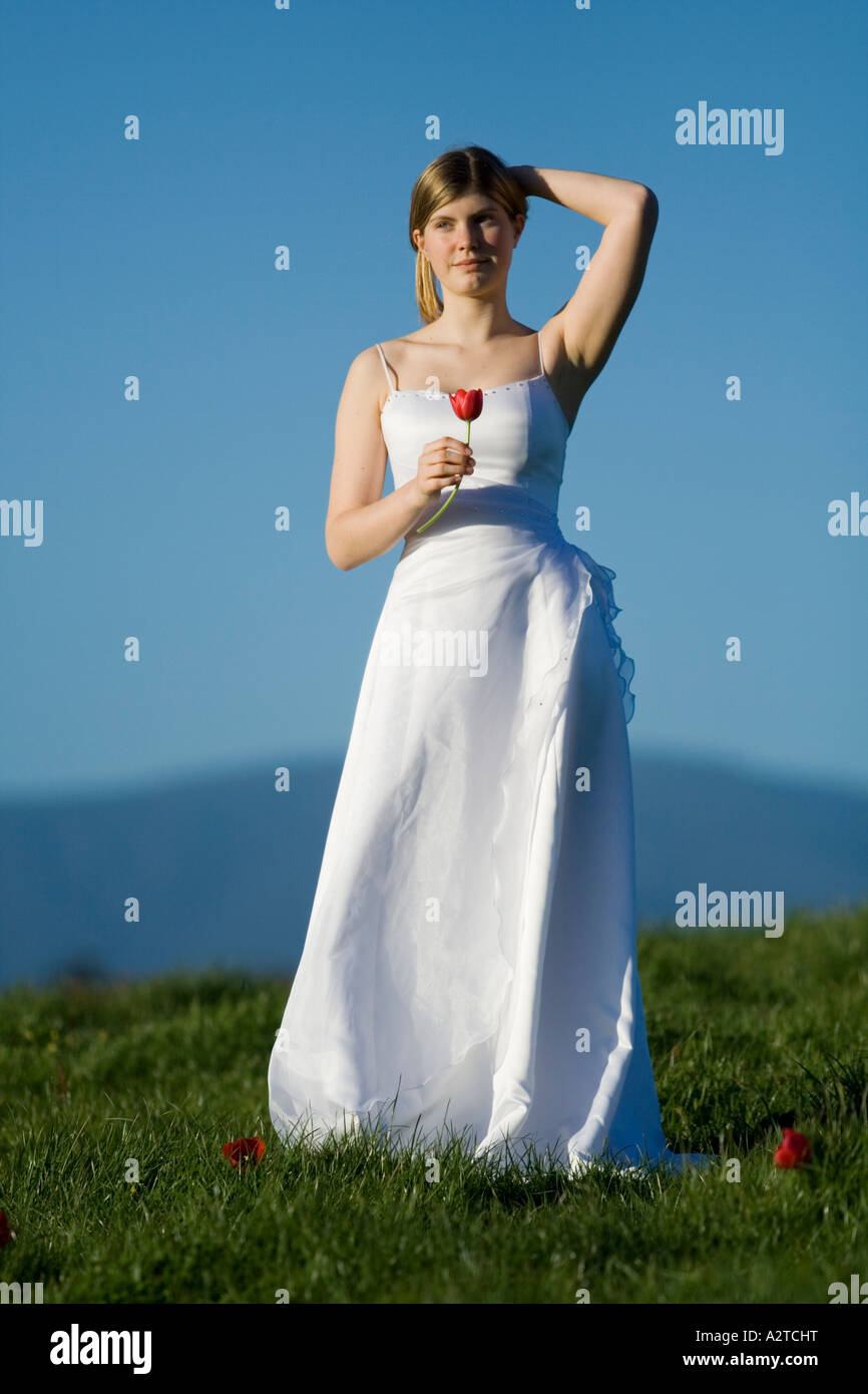 young girl woman female bride dancing in white wedding deb debutant dress on hill Stock Photo