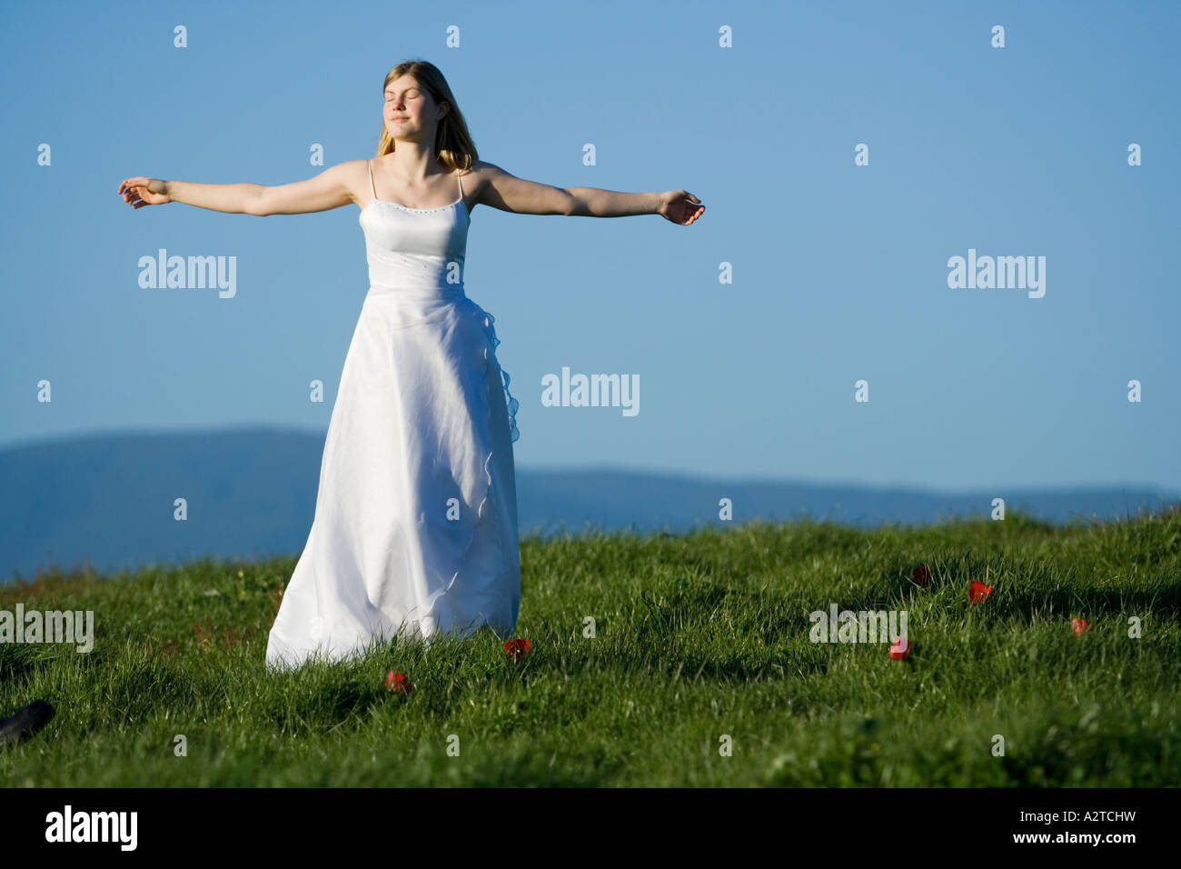 young girl woman female bride dancing in white wedding deb debutant dress on hill Stock Photo