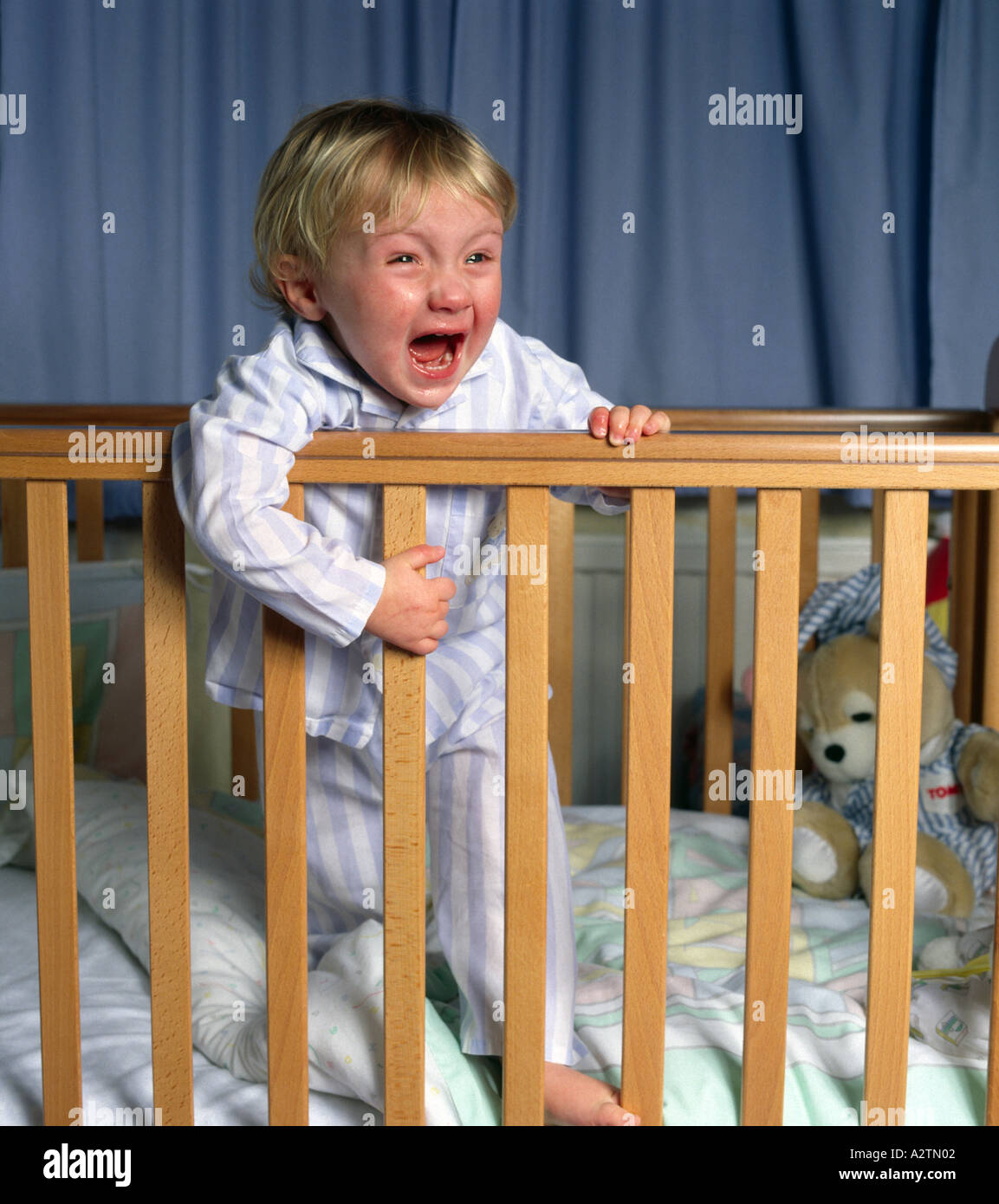 Toddler aged 2 years crying in cot Stock Photo Alamy