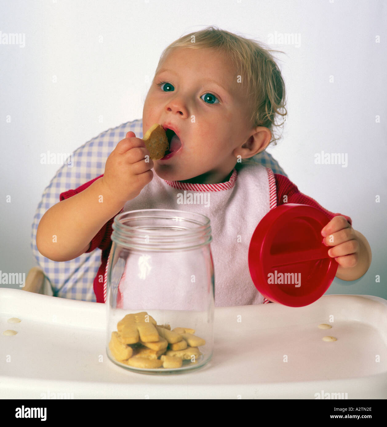 Hungry Child Eating Biscuit Stock Photos & Hungry Child Eating Biscuit