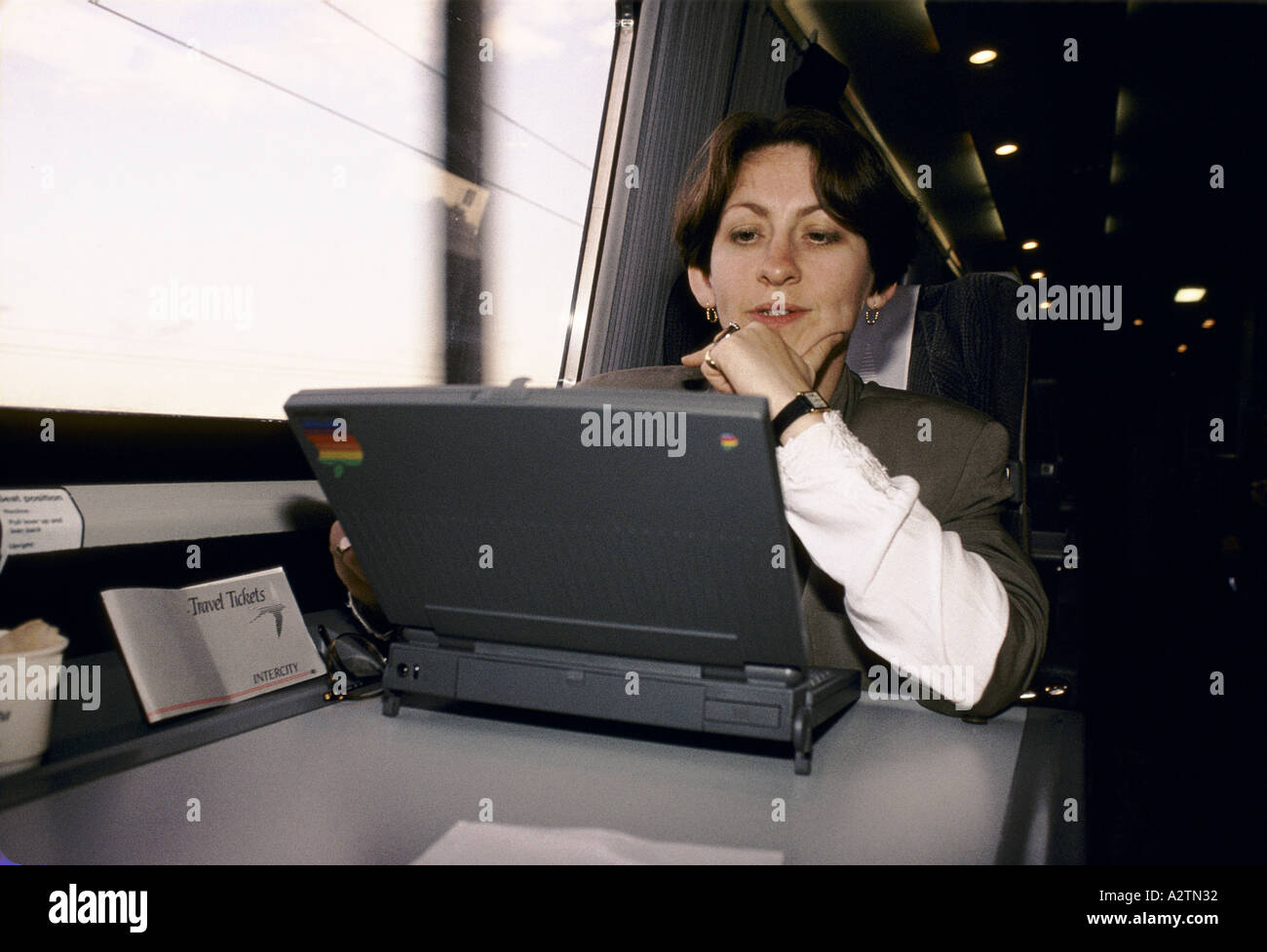 woman using laptop on train 1992 Stock Photo
