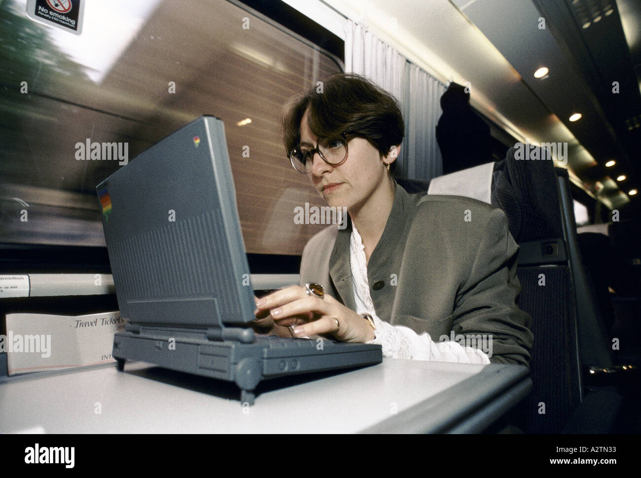woman using laptop on train 1992 Stock Photo