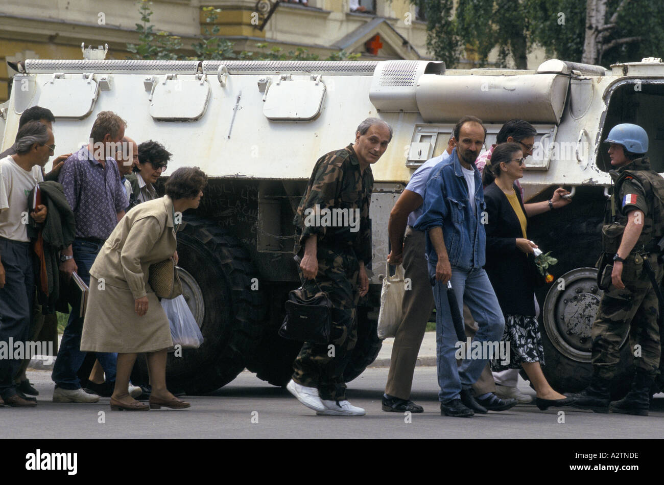 sarajevo june 1995 un tank soldier shielding people as they cross sniper susceptible roads Stock Photo