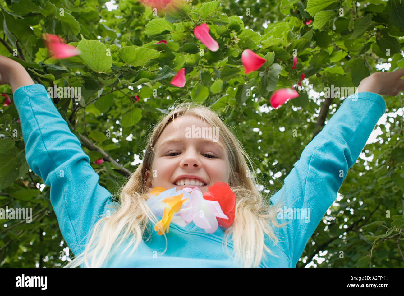 Girl throwing petals in the air Stock Photo Alamy